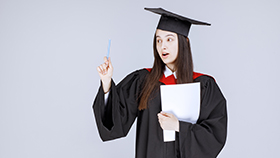 graudate student with paper pen standing before ceremony starts high quality photo